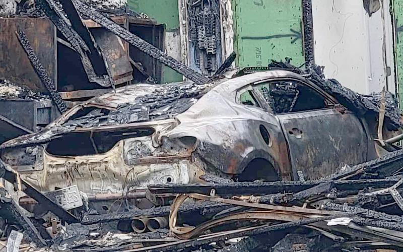 A charred Chevrolet Camaro sits in the garage of a Yulee home destroyed by fire. Photo by Amanda Bishop