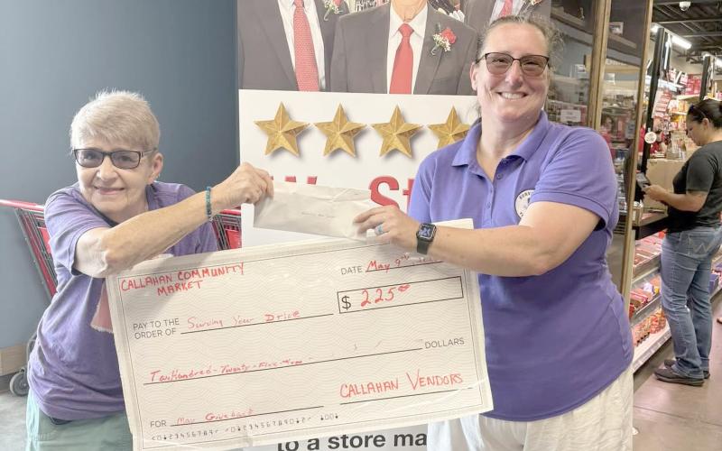 Alice Jones of the Callahan Community Market presents Sherry Weiscopf with a $225 donation for Surviving Your Drive.
