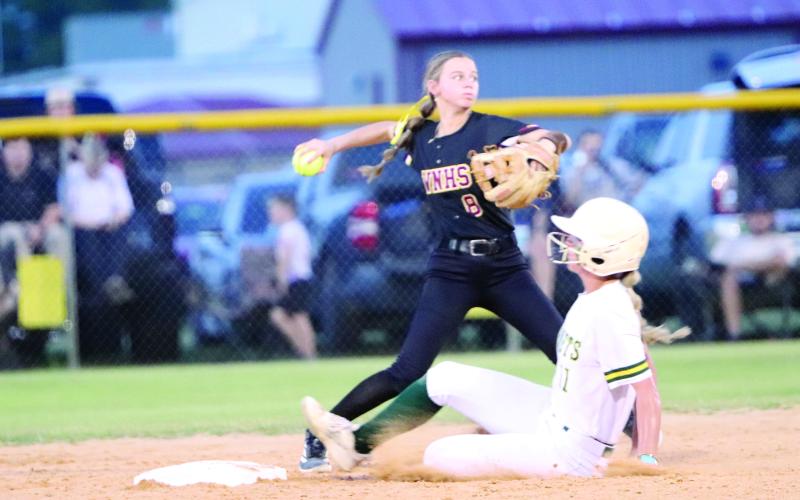 Lauren Rosepiler gets the out and throws the ball in as the Lady Warriors host Yulee May 6.