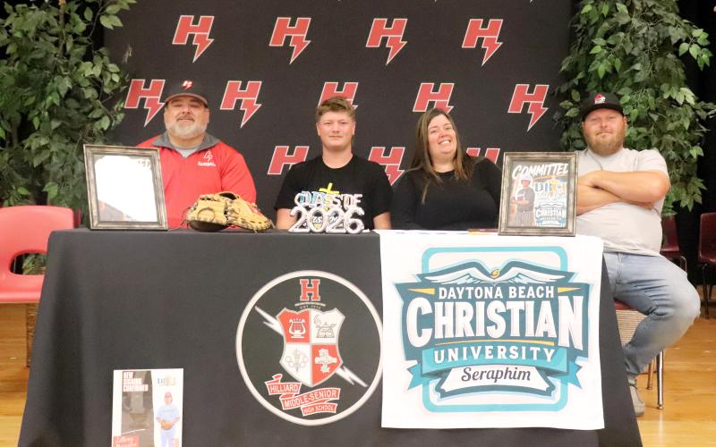 Hilliard Middle-Senior High School senior Anthony “Bubba” Musgrove is joined by mom Heather Weinberg, Corey Stone, and Coach Larry West as he signs with Daytona Beach Christian University April 28. Musgrove is a member of the Hilliard varsity baseball team and will continue to play at DBCU. Photo by Anna Newhoff