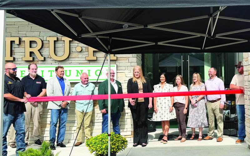 TRU-FI Credit Union officials and community members participate in a ribbon-cutting ceremony celebrating the grand opening of the credit union’s newly built Callahan branch Tuesday. The former branch was torn down after construction completed. Photo by Britney Fletcher West