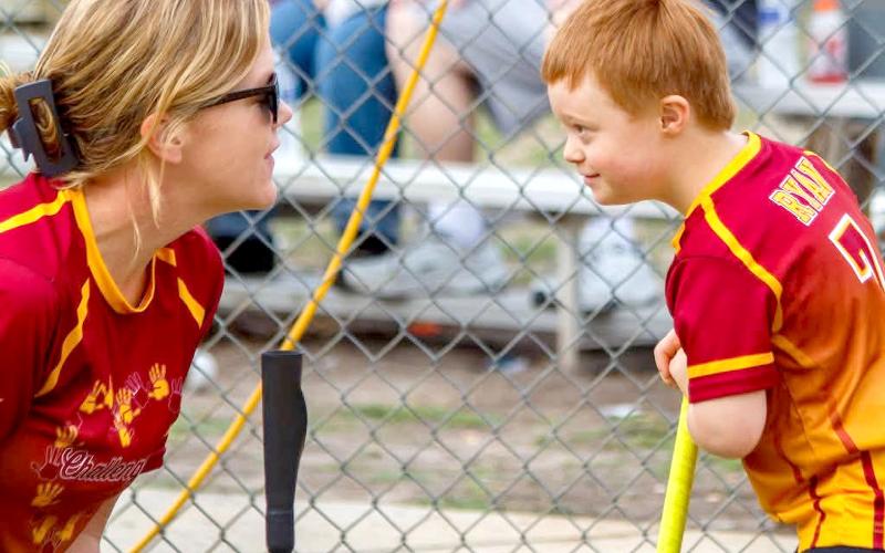 Coach Julia Brown encourages Ryan at the plate. The Callahan Challengers are expanding to include a soccer team. Photo courtesy of the Callahan Challengers League
