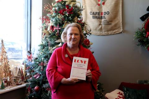 Lori Scarborough poses above with her book “Love Leads Us Home,” available on westbowpress.com and Amazon. Photo by Anna Newhoff