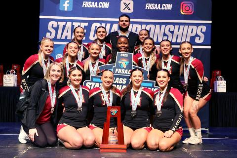 The West Nassau High School cheerleaders display the school’s 14th state championship trophy. The team won first place in the Florida High School Athletic Association Class 1A Medium Non-Tumbling Jan. 31.