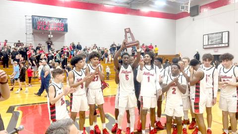 The Flashes celebrate with their district championship trophy.