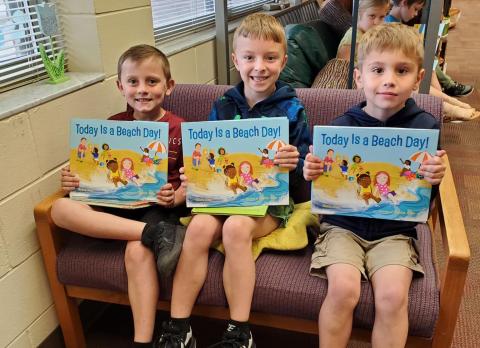 Callahan Elementary School students display books they received.