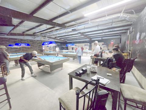 Locals enjoy playing pool at Top Hat Billiards, which may relocate to an adjacent property. Submitted