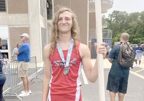 Justin Bennett poses with a javelin while wearing his state medal. He competed in the Class 1A boys javelin, placing eighth out of 18 state qualifiers after a rain delay. 