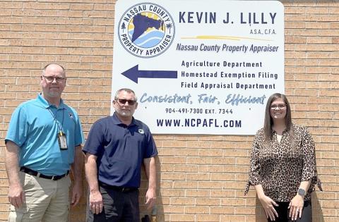 Nassau County Property Appraiser Office employees Tim Williams, Will Wood and Samantha Brandt assist residents at the Callahan office. New extended hours begin Monday in an effort to better meet citizens’ needs. Submitted