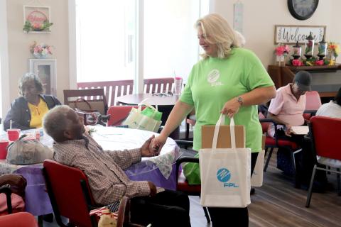 FPL External Affairs Manager Carol Saviak presents Hilliard senior Sylvester Ross with a meal kit at the Westside Senior Life Center June 18. The kits were distributed to senior citizens to help them prepare for the hurricane season, which continues through Nov. 30. 