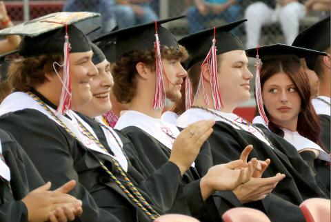 Blake Ray, Emmanuel Olivencia-Christensen, Fisher Monds, Sebastian Modica, and Abigail Miller clap for fellow graduates.