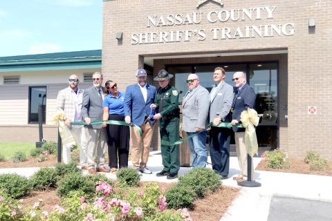 Nassau County Sheriff Bill Leeper cuts the ribbon Monday for phase two of the Nassau County Public Safety Training Complex. He is joined by U.S. Rep. Aaron Bean, Nassau County commissioners Klynt Farmer, Alyson McCullough, Jeff Gray, A.M. “Hupp” Huppmann, John Martin, and Nassau County Manager Taco Pope.
