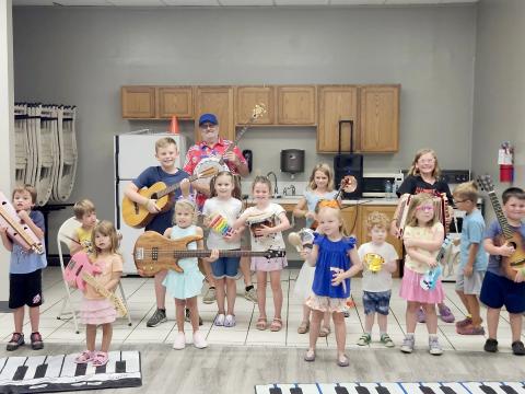 Children explore musical instruments with Joel Pace in Callahan June 16.