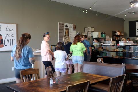 Customers wait to order at Sweet As Cyn Coffee House and Donuts Friday. Sweet as Cyn received $1,600 in donations from local business to pay it forward to customers.