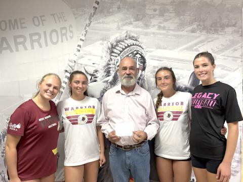 West Nassau High School volleyball teammates Kaycie Turner, Gracie Ware, Parker Madden and Skylar Thien present Don Nichols with a donation to the Callahan Masonic Lodge’s Angel Tree program. 