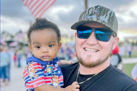 Youth Pastor Ethan Thompson holds Isaiah, who will be a year old Saturday. 
