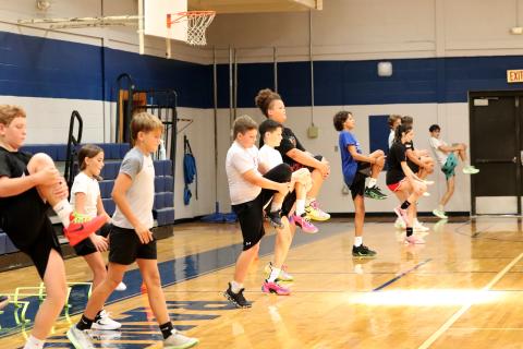 Campers warm up at the start of camp. 