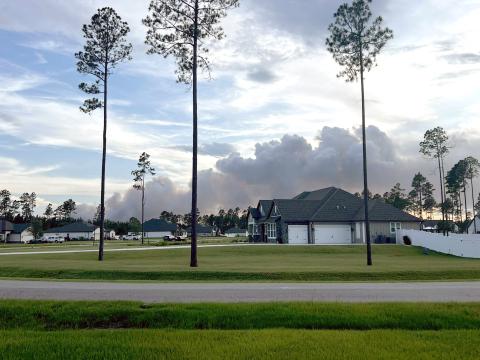 Smoke from the Rowe Road Fire billows into the sky Friday evening in Hilliard. The fire grew to 128 acres and its cause is under investigation. Photo courtesy of Darryl and Tamara Cawley-Del Rio
