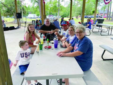 Mayor John Beasley joins family members at top while numerous golf cart owners decorated their rides in patriotic colors before hitting the streets of Hilliard to celebrate America. 