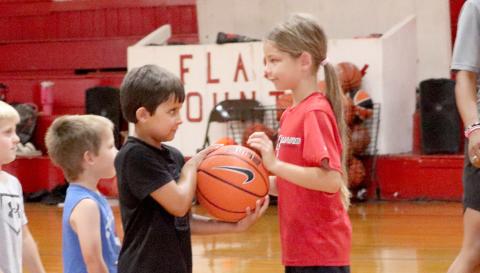 Tynlee Carmichael hands Drake Thompson the ball. Photos by Anna Newhoff