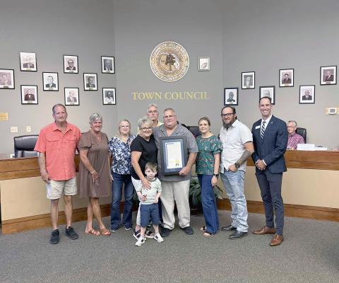 Hilliard Mayor John Beasley is joined by his family, including wife Donna, and Florida League of Cities Director of Member Services and Training Chris Holley Thursday night. Beasley has spent 25 years as a public servant, first elected Nov. 7, 2000. He currently acts as mayor of the town. Photo by Alicia Head