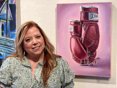 Brenda Schwend stands by her painting “I am speaking.” Her show opened Tuesday in the Kent Campus Gallery of Florida State College at Jacksonville. Submitted