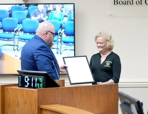 District 5 Nassau County Commissioner Klynt Farmer presents a proclamation to Northeast Florida Fair Association Vice President Paulette Kirkland in support of a funding request via the Florida Department of Agriculture and Consumer Services for an Agriculture Education and Promotion Facility grant.