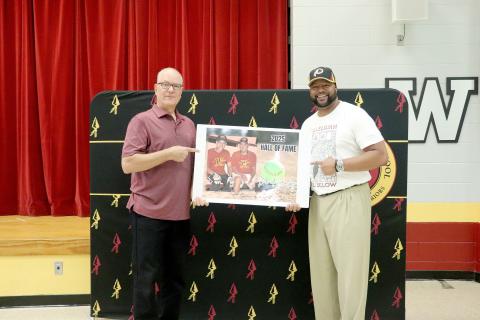 Raymond Fachko and Russell Palmer, Jr., hold a photo of David Crosby. All three of them were inducted into the West Nassau High School Hall of Fame Friday night