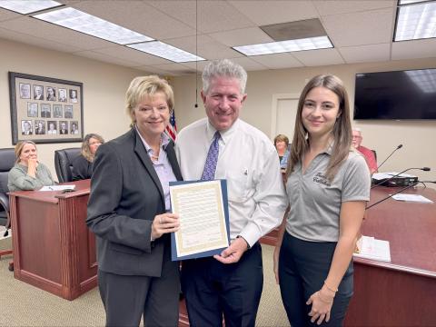 Emily’s Promise Presid-ent Doug Adkins and Vice  President Janet Adkins join Callahan Town Coun-cilwoman Jacquelyn Fle-ming Monday. The council declared October as Emily Adkins Blood Clot Awareness Month. Photo by Anna Newhoff