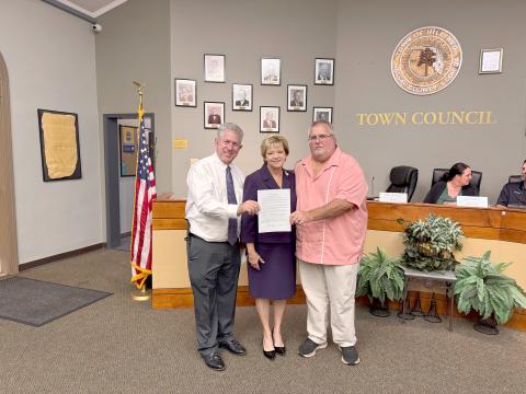 Hilliard Mayor John Beasley stands with Emily’s Promise President Doug Adkins and Vice President Janet Adkins. He read a proclamation in honor of the town naming October as Emily Adkins Blood Clot Awareness Month. The Adkins aim to raise awareness and help stop preventable blood clot related deaths. Photo by Anna Newhoff