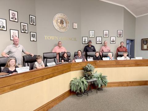 The fifth-grade mayor and council members join Hilliard Town Council members Dallis Hunter, Lee Pickett, Joe Michaels, and Jared Wollitz, Mayor John Beasley, and Town Clerk Lisa Purvis. Photo by Anna Newhoff