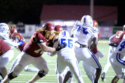 Junior Clayton Lee blocks for the Warriors Friday night. West Nassau won 48-12 to advance to the second round of the postseason. 
