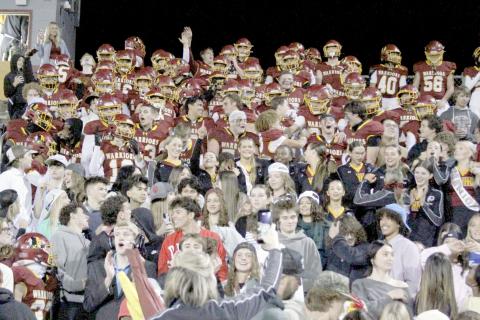 The Warrior football team joins The Tribe student section in the stands after the game to celebrate their victory over Fernandina Beach Friday. 