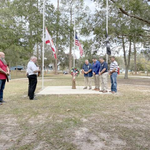 U.S. Rep. Aaron Bean visits with area residents at the Town of Hilliard’s Veterans Appreciation Ceremony Saturday morning. Bean spoke about respect for the sacrifices and services the veterans provided Americans by serving in the military. Submitted