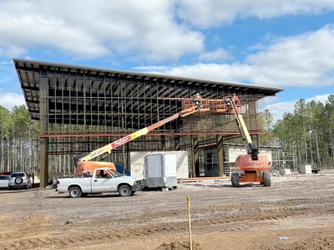 The contractor installs knotwood siding on the airnasium at the Westside Regional Park. The first phase of the park should open in early summer.