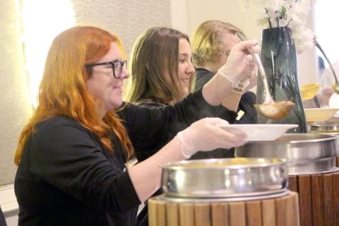 Bowls of soup are served up during Barnabas Center’s 12th annual Empty Bowls event Nov. 25. The event raised $50,000, including the online auction of several locally hand-painted bowls, pictured above right. Photos by Marisa DeMar