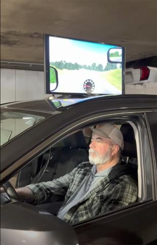 Mike Weiscopf demonstrates the new simulator that allows participants to see how drugs and alcohol impair their driving. Submitted