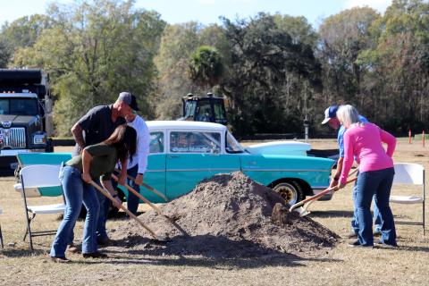 David and Lisa Hicken break ground Dec. 23 at the Hicken Power Drag Strip as Nassau County business owner Heather Hagan and Southern Rail Construction workers Donald Goff and Dwayne Kirchner join them. The Hickens speak to those in attendance at top. The drag strip will be located behind the oval race track already in place on the property, which is located at 543455 U.S. 1, Callahan. Photos by Anna Newhoff