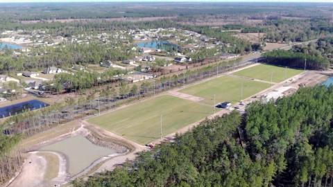 Pictured above are the airnasium (open-air-gymnasium), the outfitter and restroom building, a birthday pavilion, and the amphitheater pad of the new Westside Regional Park. The first phase of the park should open by early summer. Three new FIFA regulation-size soccer fields recently received sod and are pictured below. Photos courtesy of Nassau County officials
