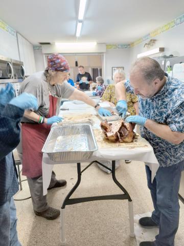 Callahan Methodist Church Pastor Bodie Riddle and David Haskett carve turkey as the church congregation prepares to serve Thanksgiving dinner to community members Nov. 22. The tradition began 45 years ago. This year’s menu included smoked turkeys, a variety of side dishes, and desserts. Attendees enjoyed the meal and fellowship with other patrons. Photos by Susie Bass