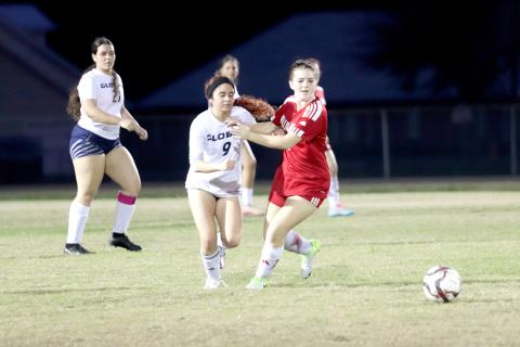 Hannah Wollitz battles a Lady Kodiak as they race for the ball. 