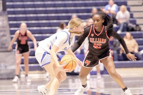 Hilliard eighth-grader Justice Alderman guards a Lady Royal in the Florida High School Athletic Association Rural Class state semifinal game at the University of North Florida Feb. 24. The arena was packed with Hilliard fans. 
