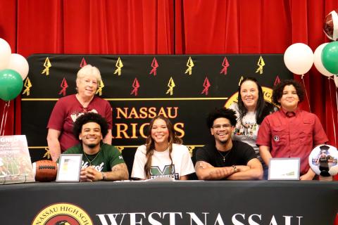 West Nassau High School senior Danyelle Bell is joined by mom Sarah Monds, grandmother Ellen Monds, and brothers Chaz Davis, Prentiss Davis, and Brisyn Holmes as she signs with Mercyhurst University March 9. 