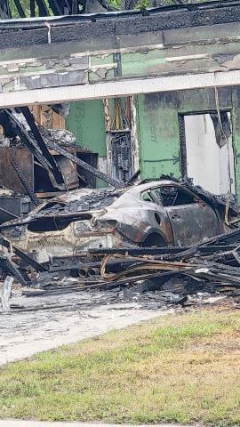 A charred Chevrolet Camaro sits in the garage of a Yulee home destroyed by fire. Photo by Amanda Bishop