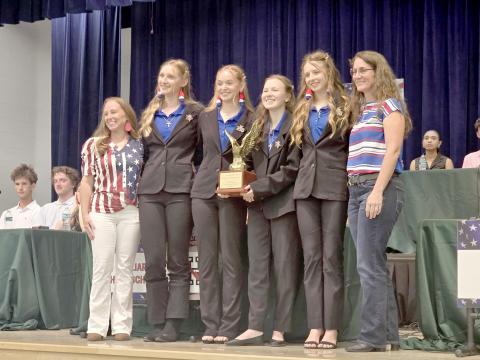 Lily Zettler, Lainey Walters, Amelia Hawkes and Eden Hawkes celebrate the Homeschool team’s victory April 16 at Wildlight Elementary. Submitted