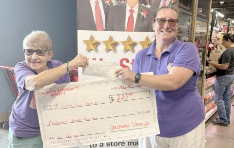 Alice Jones of the Callahan Community Market presents Sherry Weiscopf with a $225 donation for Surviving Your Drive. 