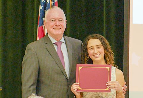 HMSHS senior McKenzie Roberts receives a $10,000 scholarship for writing an award-winning essay.