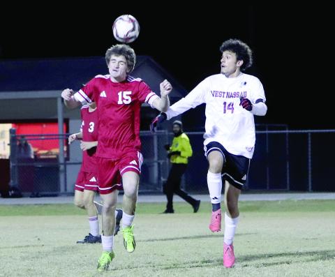 Hilliard soccer player Clayton Floyd hits a header with Warrior David Ortega nearby in December. 