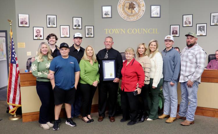 Hilliard Town Council President Kenny Sims receives a resolution recognizing his 20 years as a public servant.