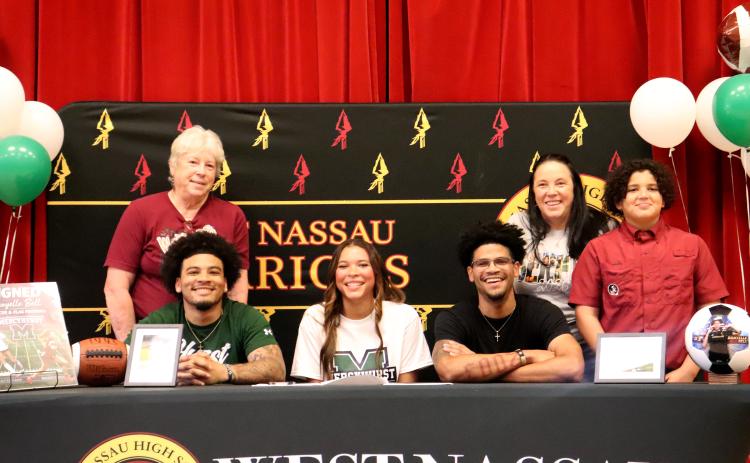 West Nassau High School senior Danyelle Bell is joined by mom Sarah Monds, grandmother Ellen Monds, and brothers Chaz Davis, Prentiss Davis, and Brisyn Holmes as she signs with Mercyhurst University March 9.